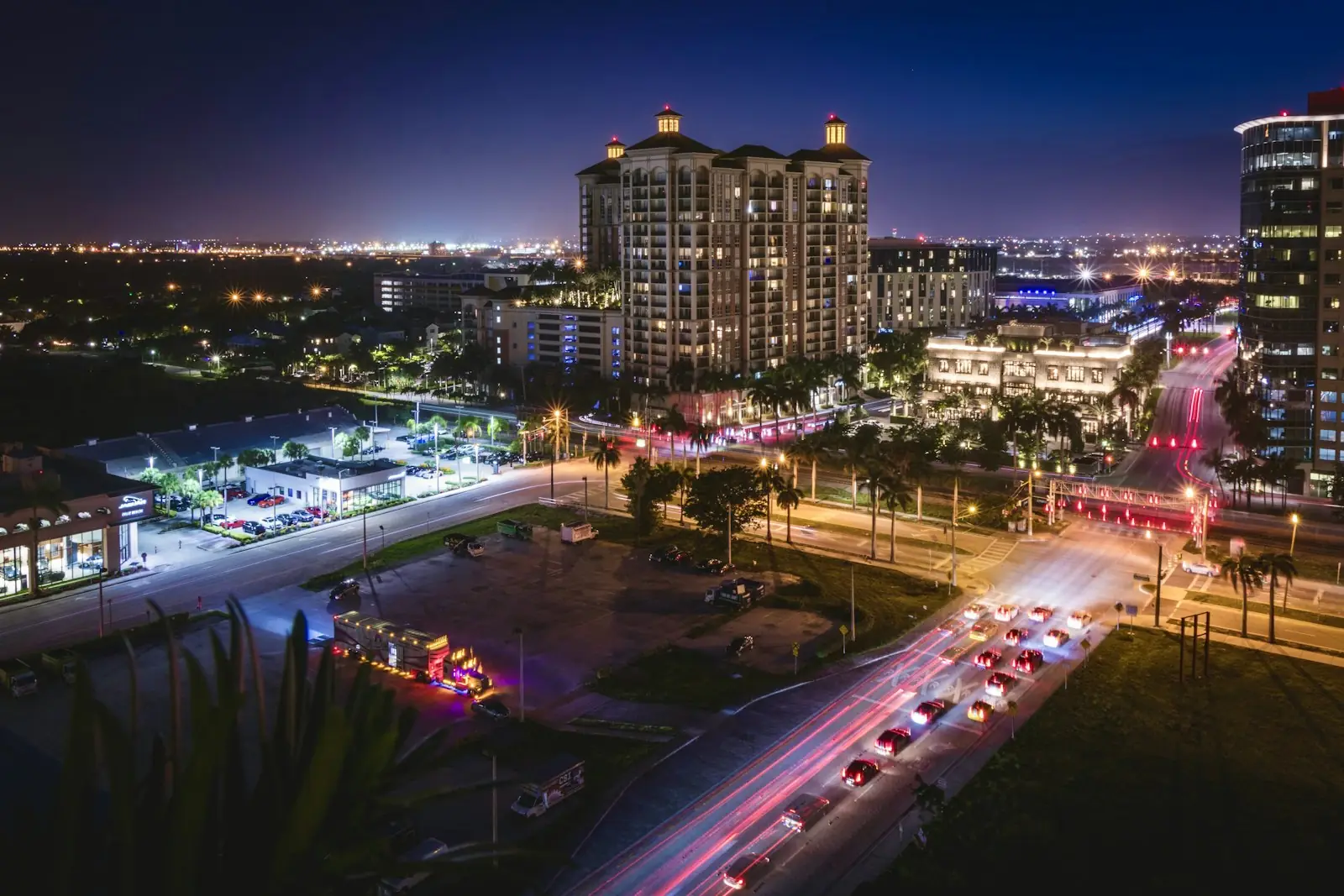 Downtown West Palm Beach at night, with light trails from traffic below the towers